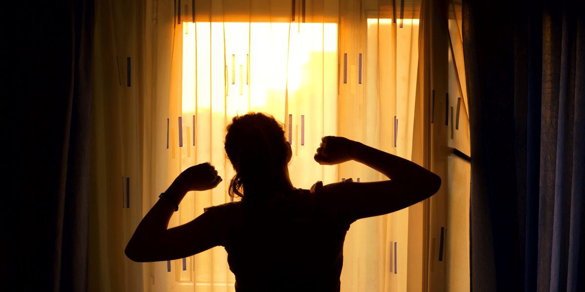focused woman stretching looking at a window