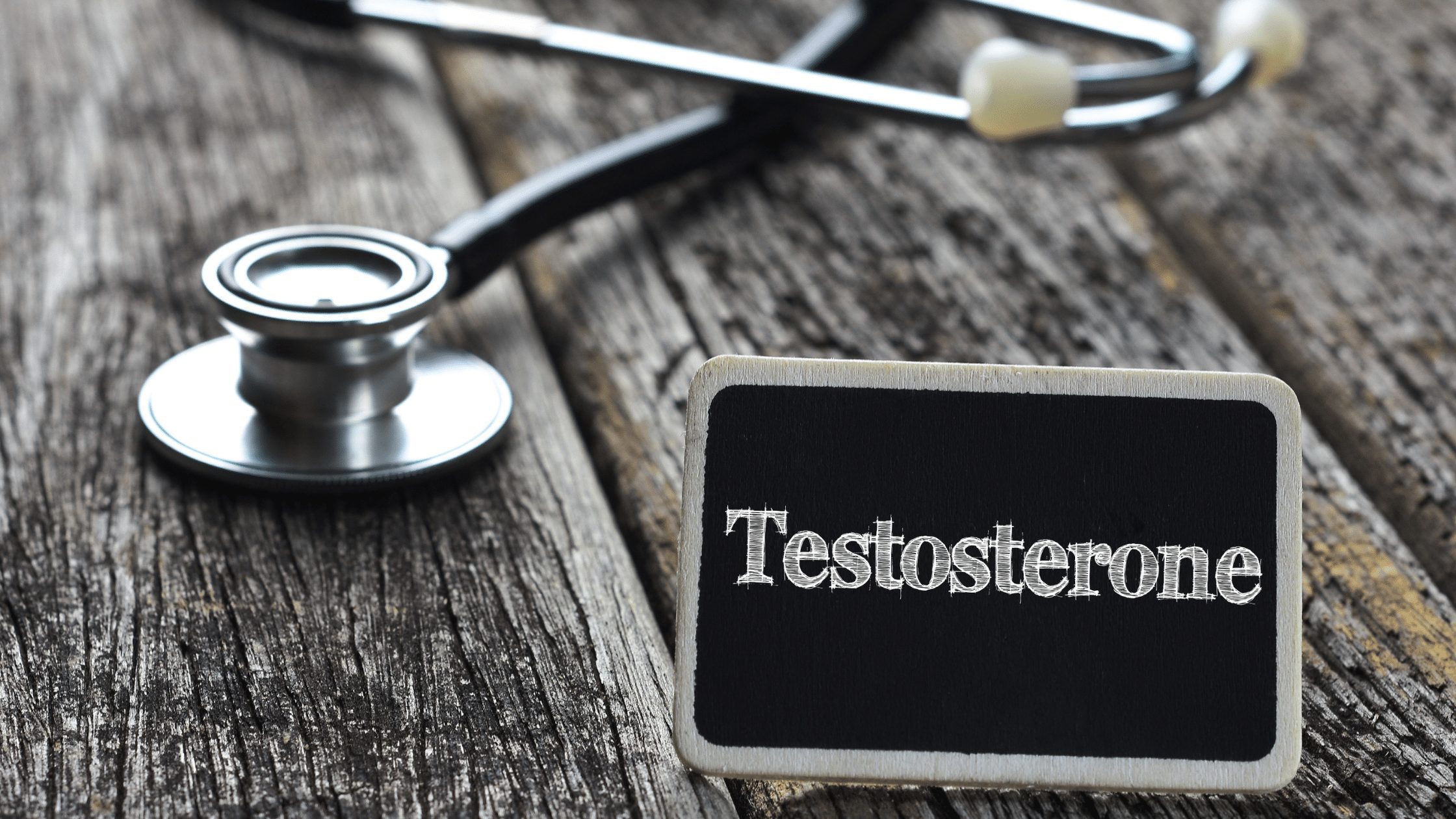 Testosterone written on a chalkboard with medical equipment in the background